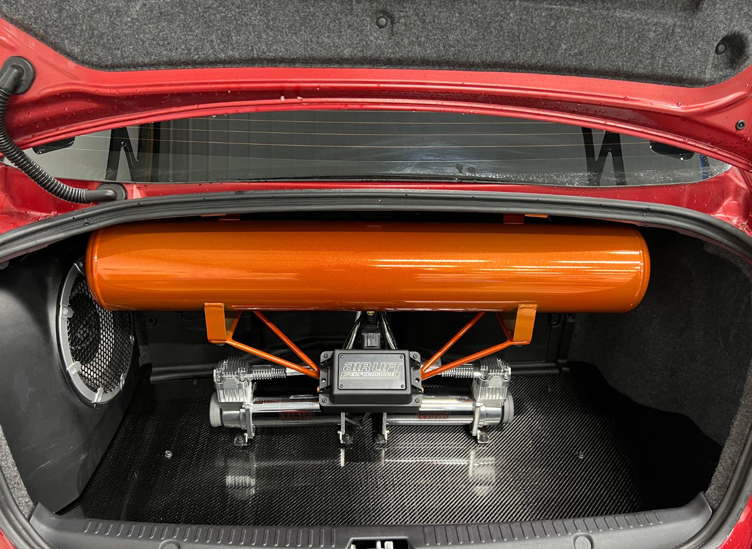Custom trunk-mounted tank and parachute hardware in Cora's Evo X