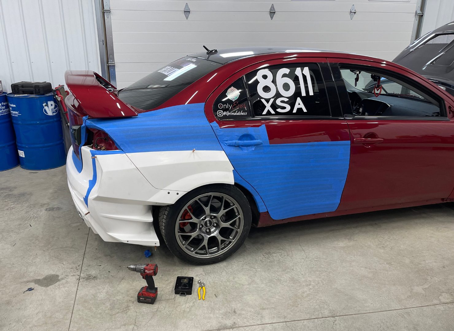 Evo X with white widebody panels taped in place for fitment