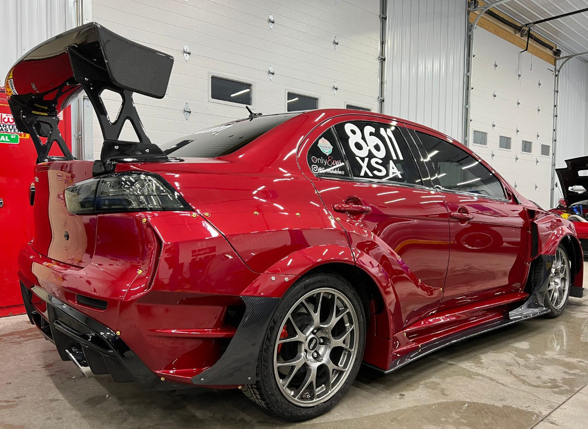 Red Evo X rear quarter panel removed during bodywork