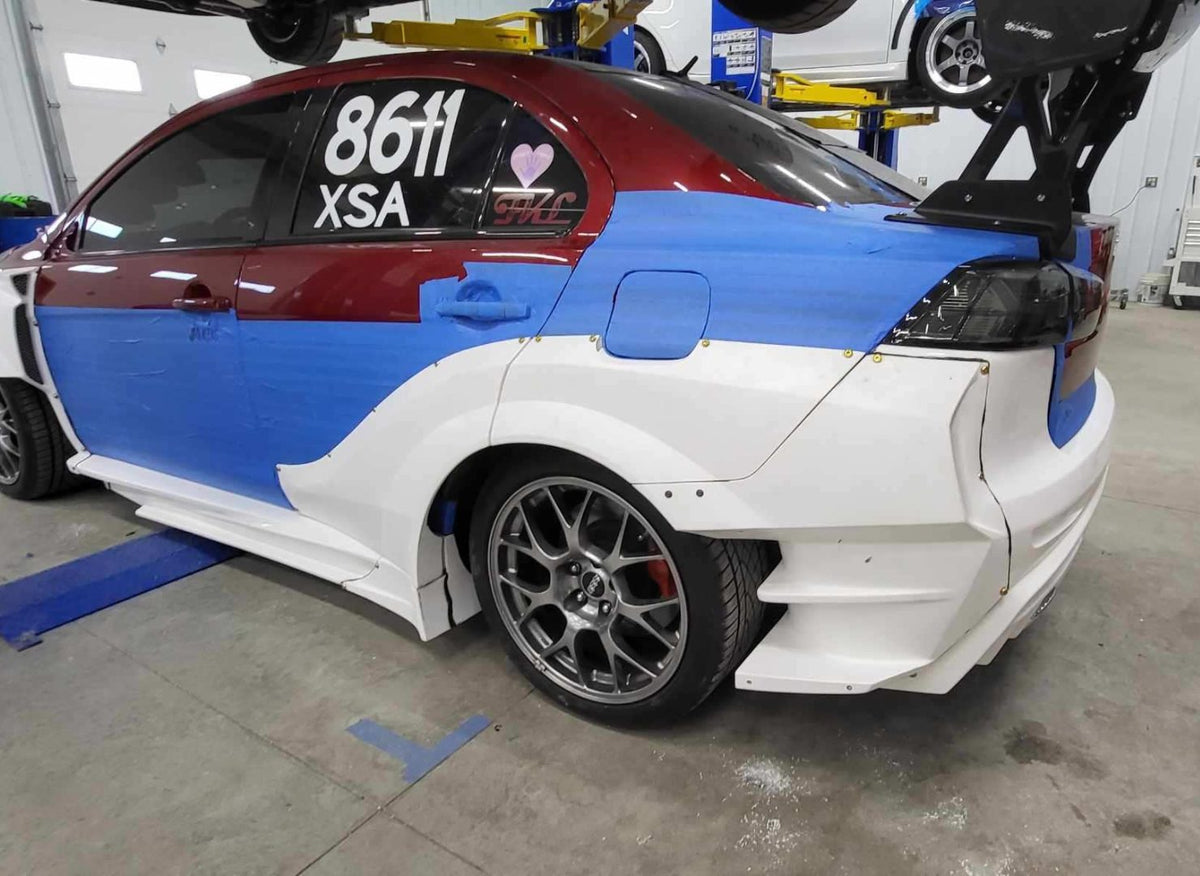 Side view of Evo X widebody panels taped in place for fitment