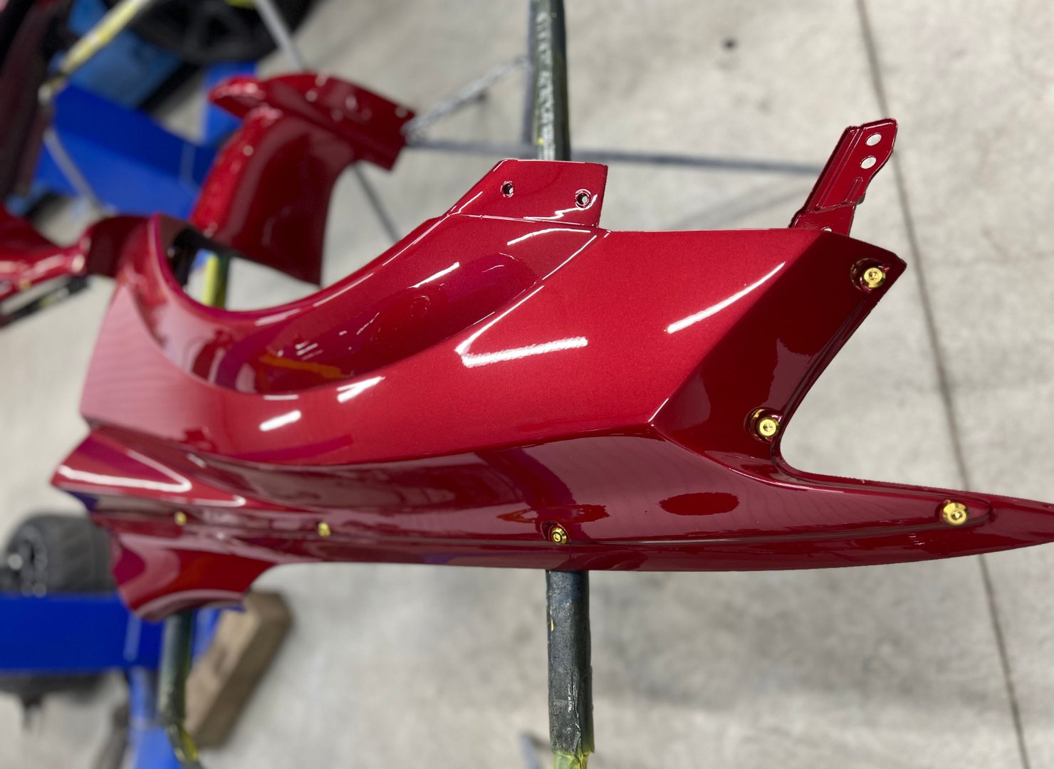 Custom red Evo X body panel with exposed fasteners