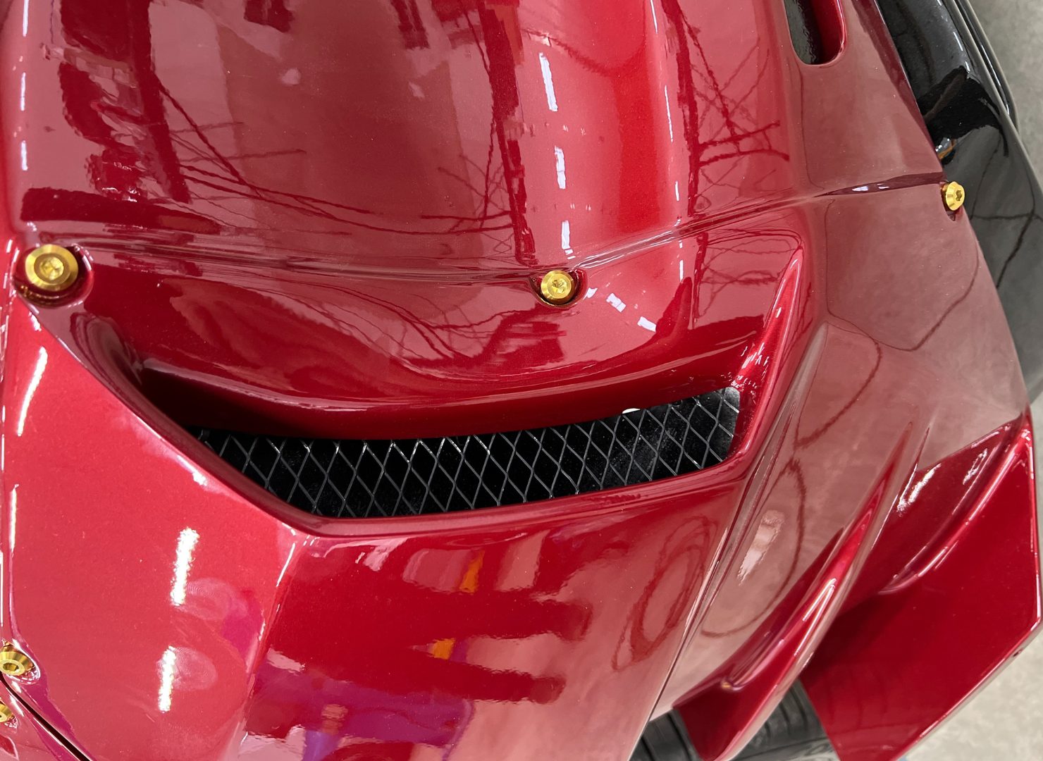 Close-up of the vented red Evo X hood with hood pins