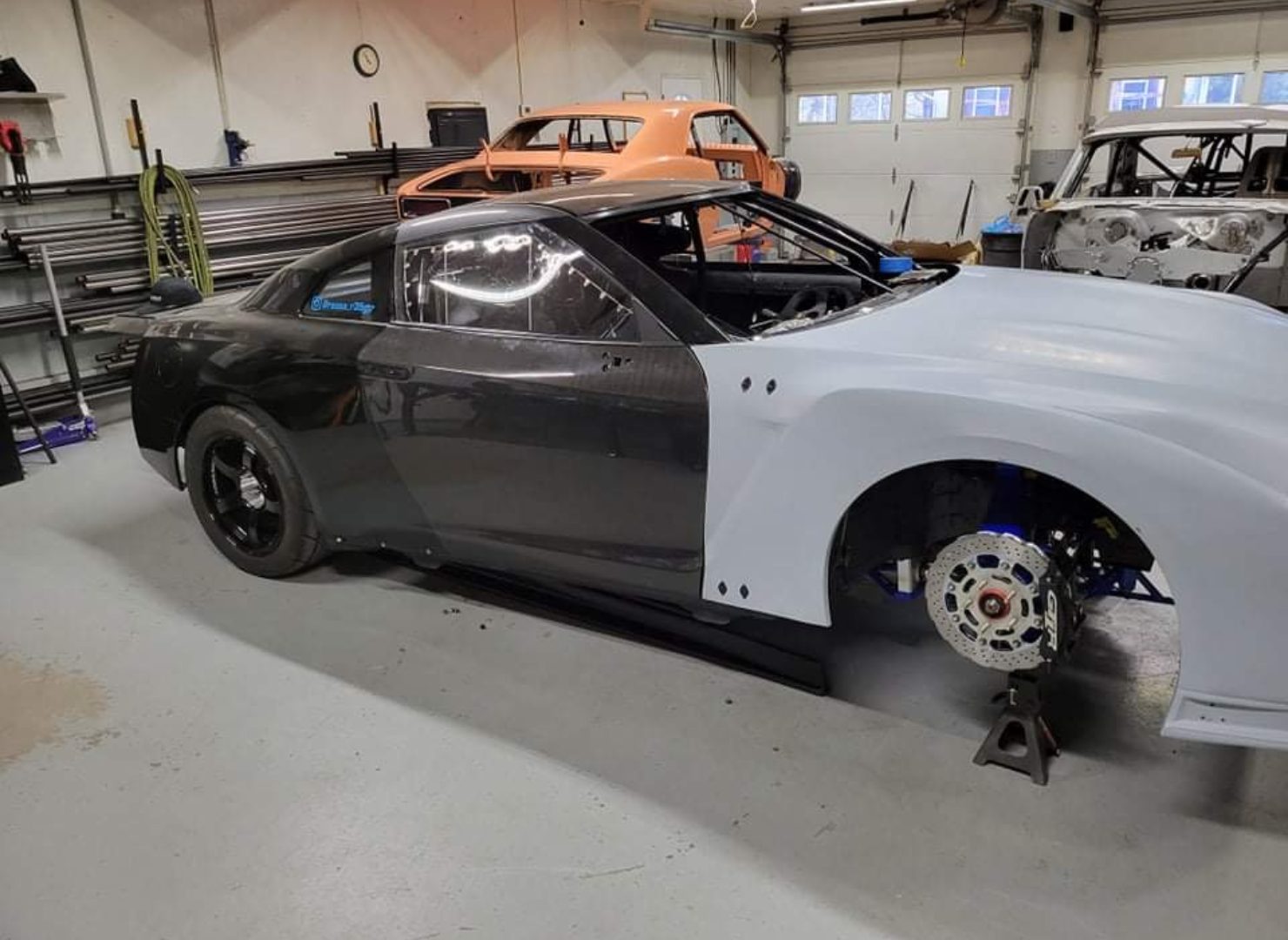 R35 GTR chassis with a white front body panel during assembly