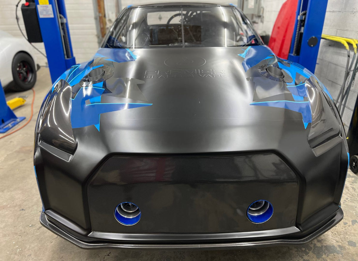 Front view of the blue and black R35 GTR with hood pins