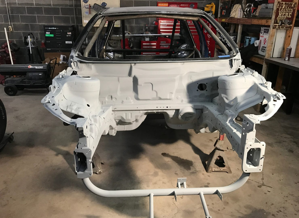 Rear view of a stripped Evo X chassis during fabrication
