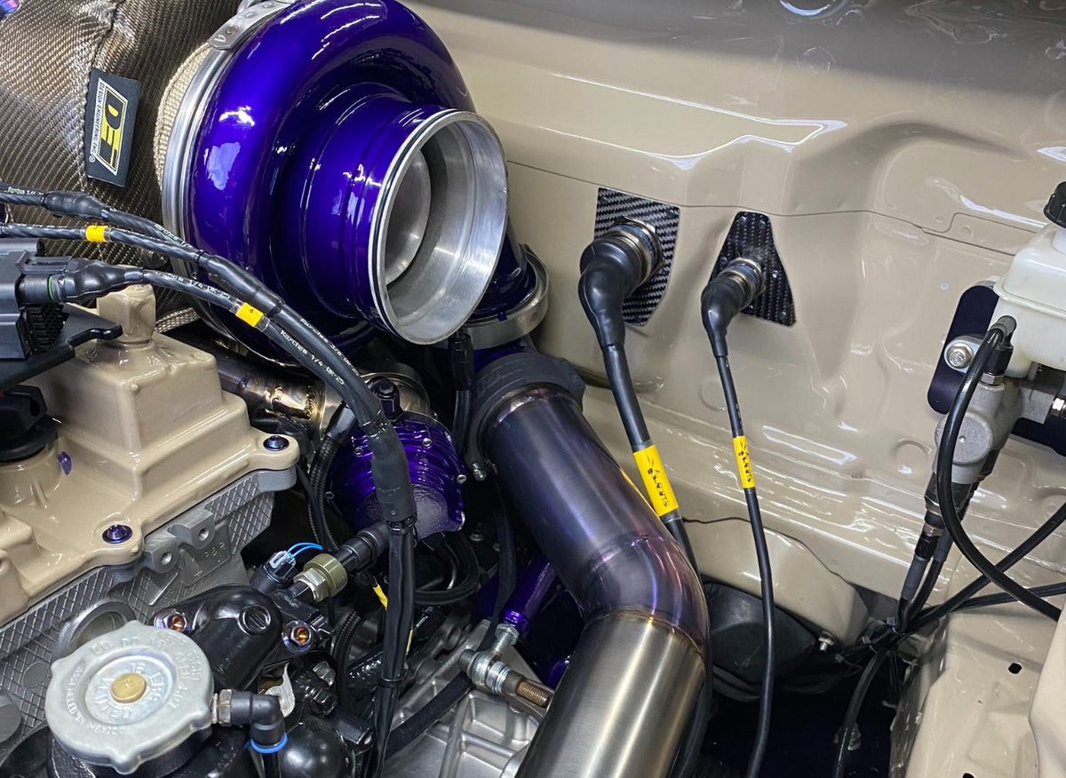 Close-up of the large turbo and purple piping in an Evo X