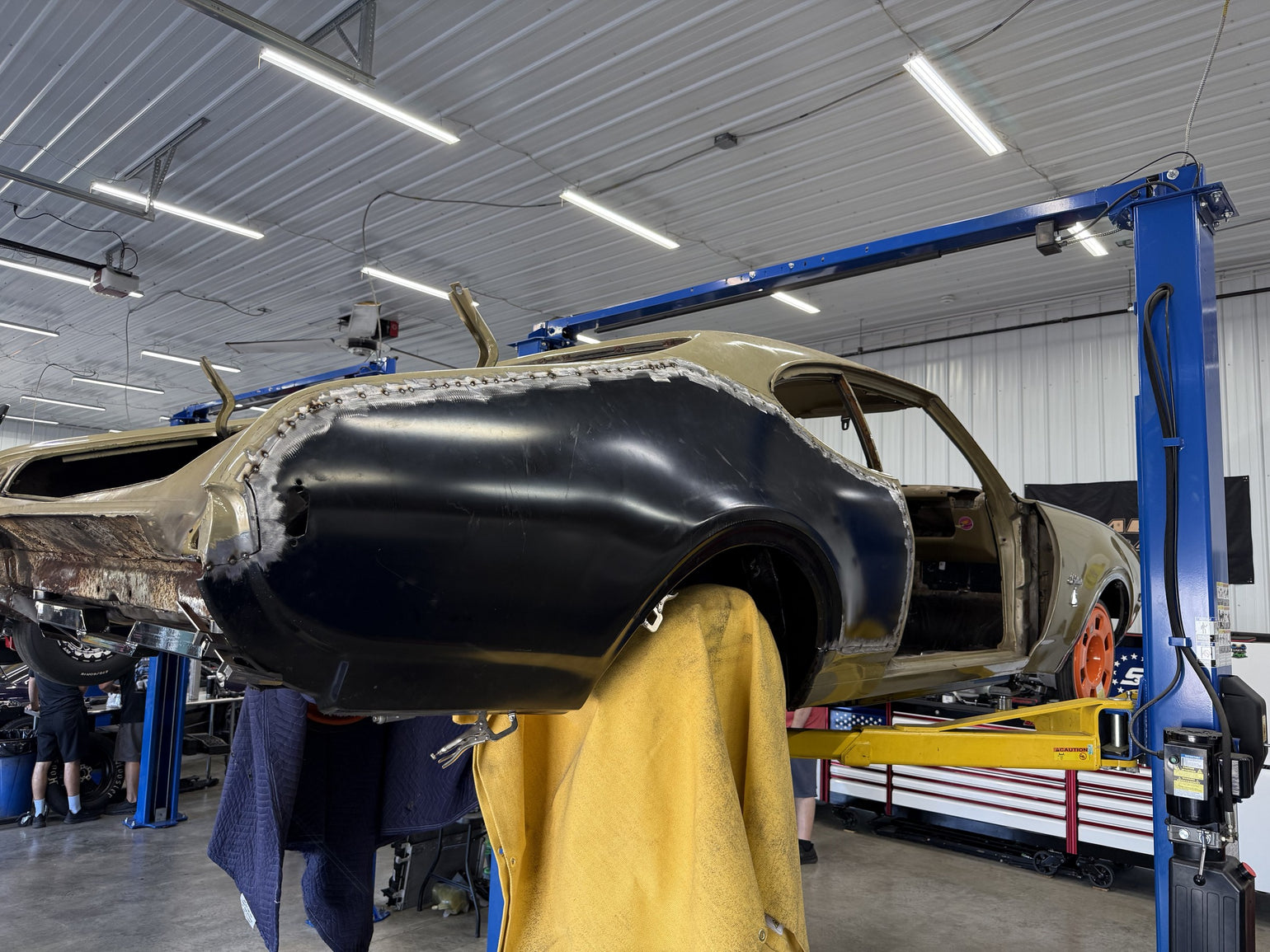 Quarter-panel metal fabrication in progress on a Cutlass
