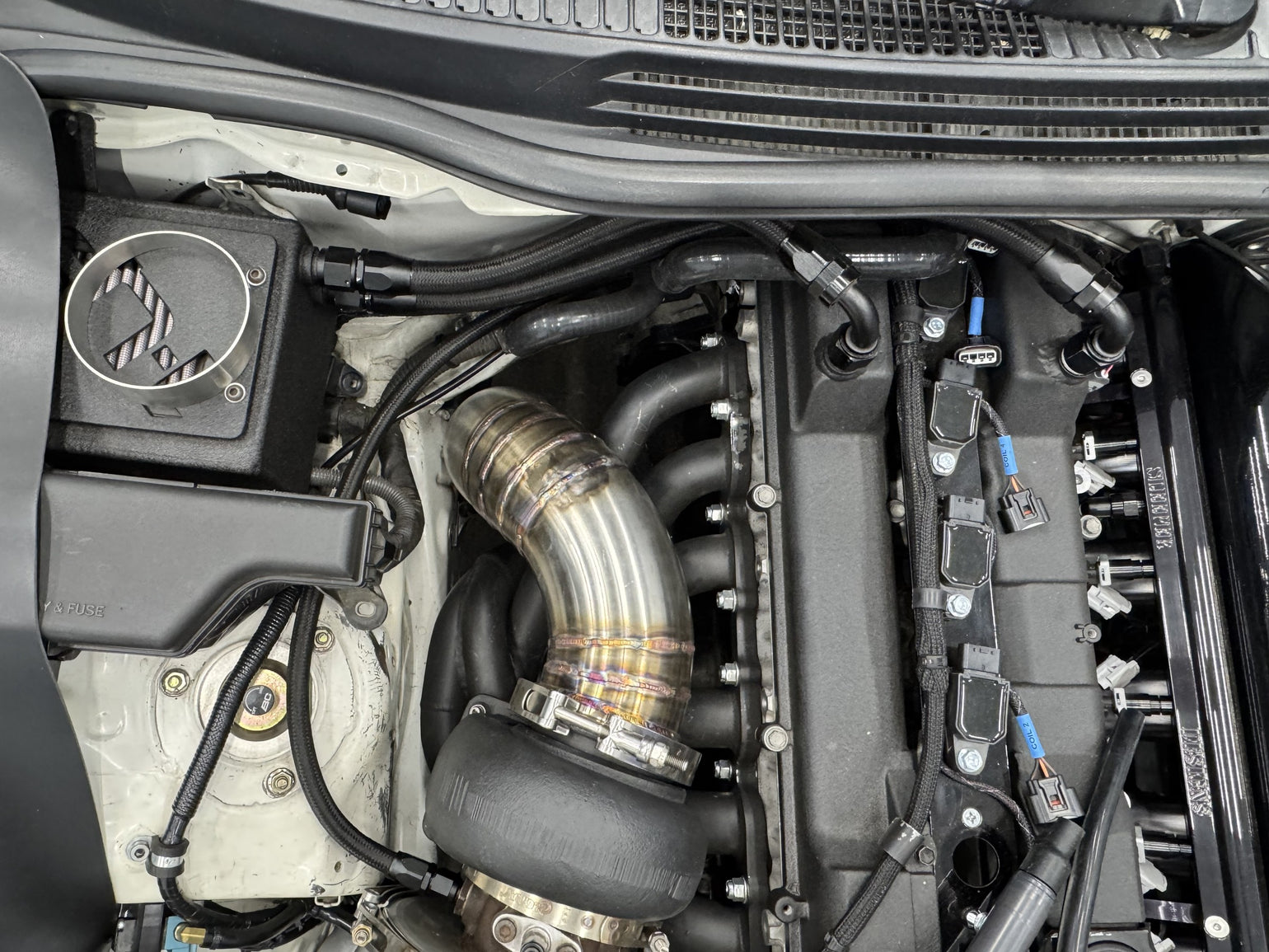 Custom turbo piping installed in a Lexus IS300 engine bay