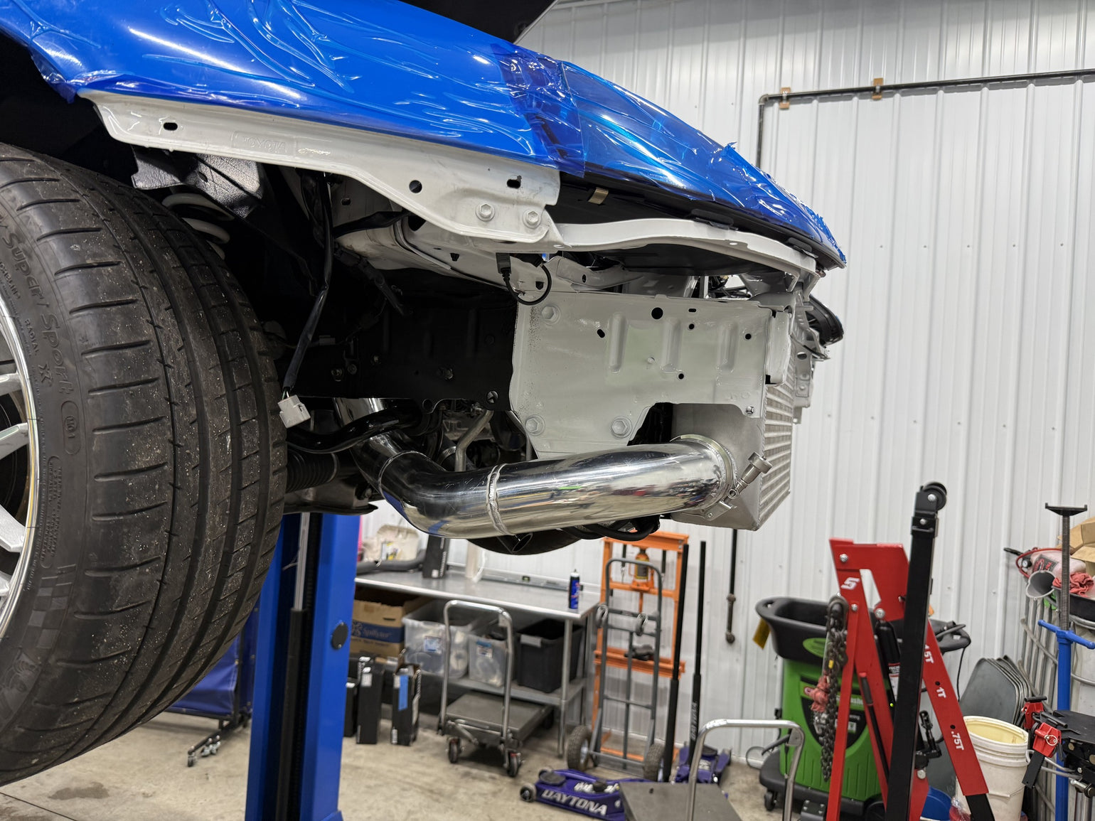 Custom charge-pipe routing behind the front bumper of an MK4 Supra