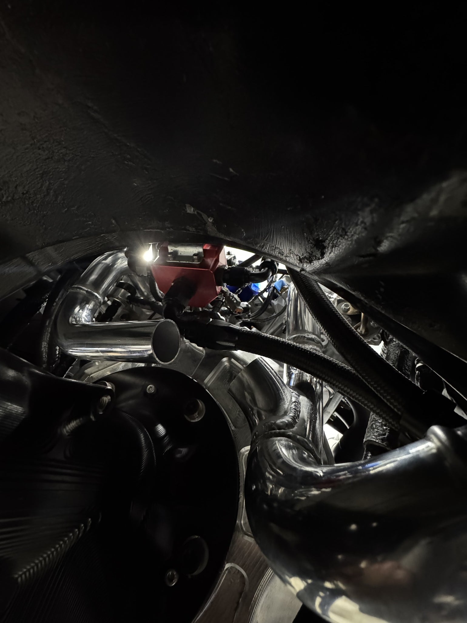 Custom stainless exhaust piping installed beneath a Nissan GT-R