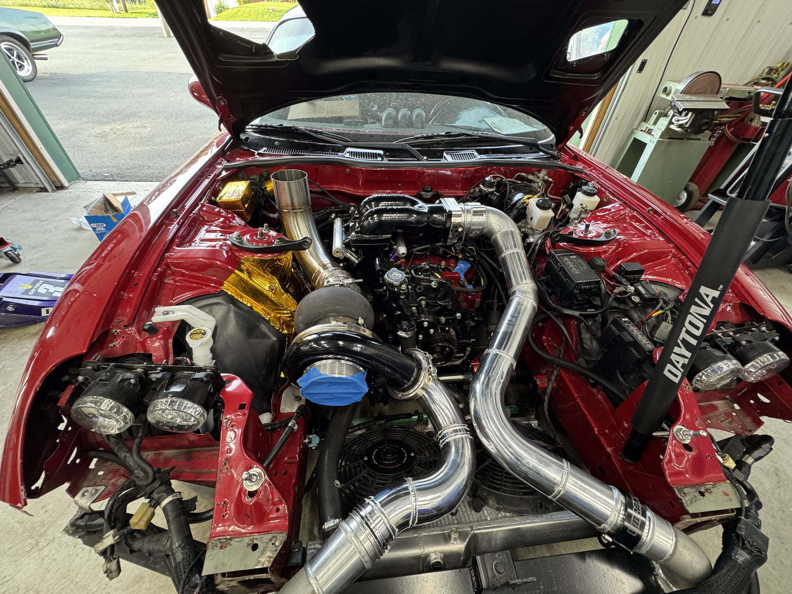 Custom turbo and charge piping installed in an RX-7 engine bay