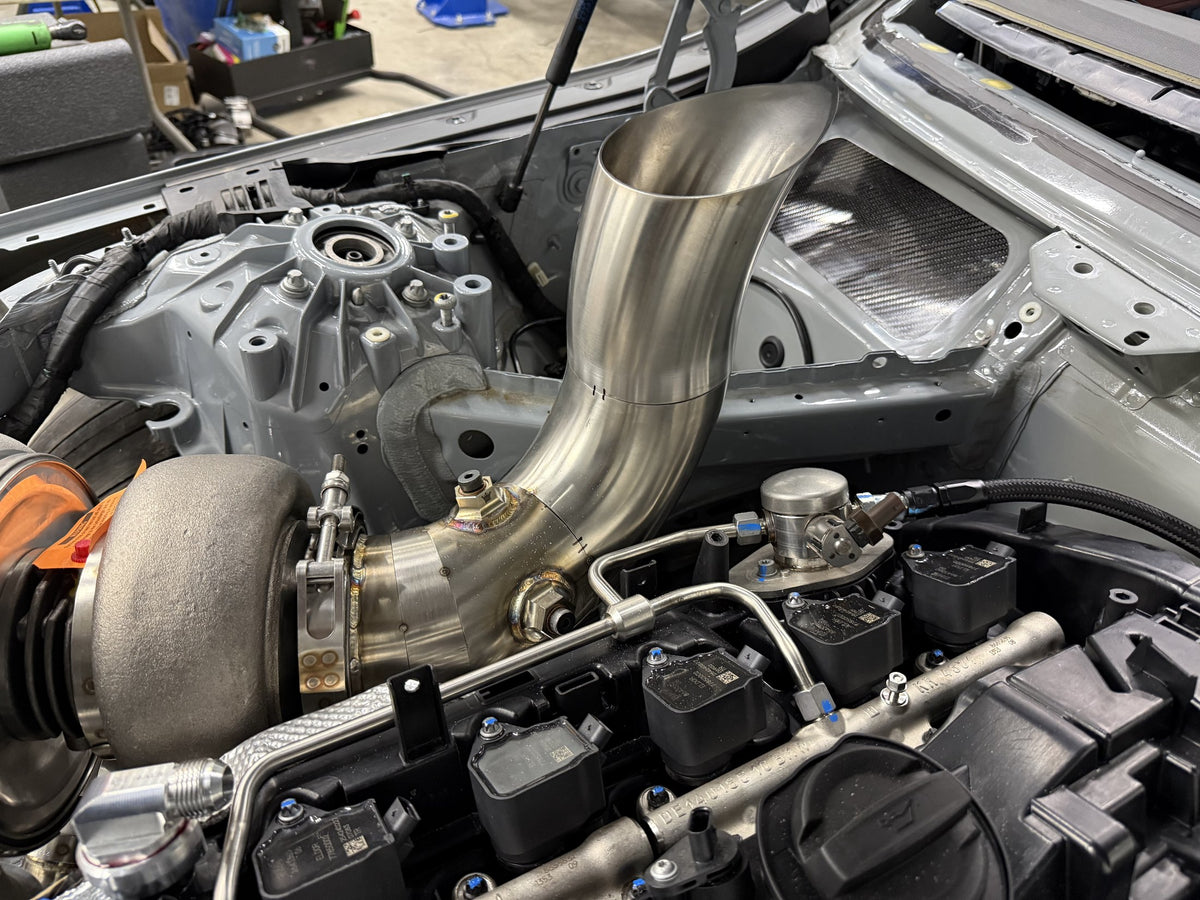 Custom hood-exit exhaust fabrication on the Grade A Garage BMW M240