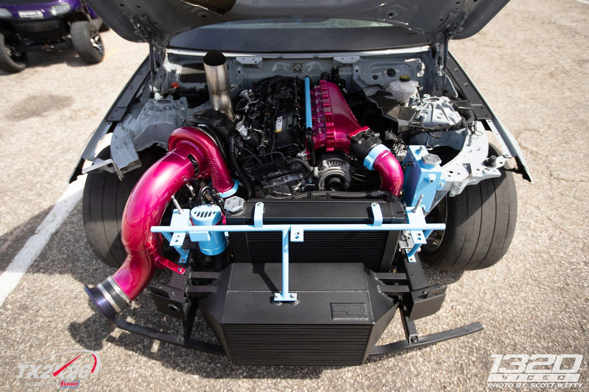Pink charge piping in the Grade A Garage BMW M240 engine bay